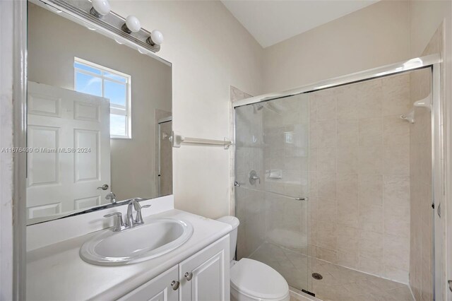 bathroom featuring vanity, toilet, and walk in shower