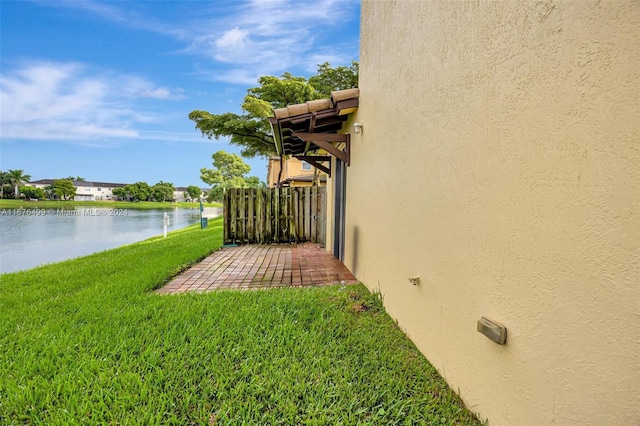 view of yard featuring a patio area and a water view