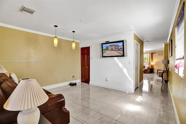 sitting room with crown molding and light tile patterned floors