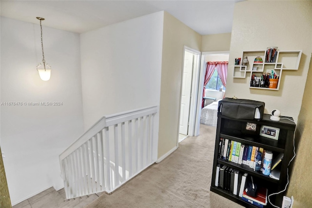 hall featuring light colored carpet