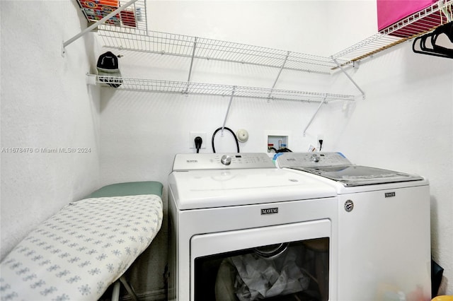 laundry room with washing machine and clothes dryer