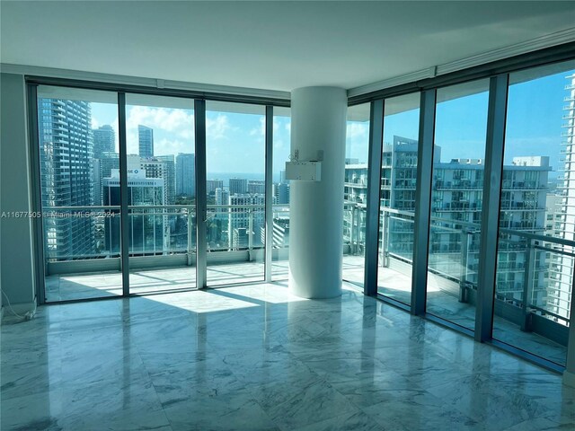 92 SW 3rd Unit 3605, Miami, FL 33130 - empty room featuring a view of city, marble tiled floors, a wall of windows, and plenty of natural light