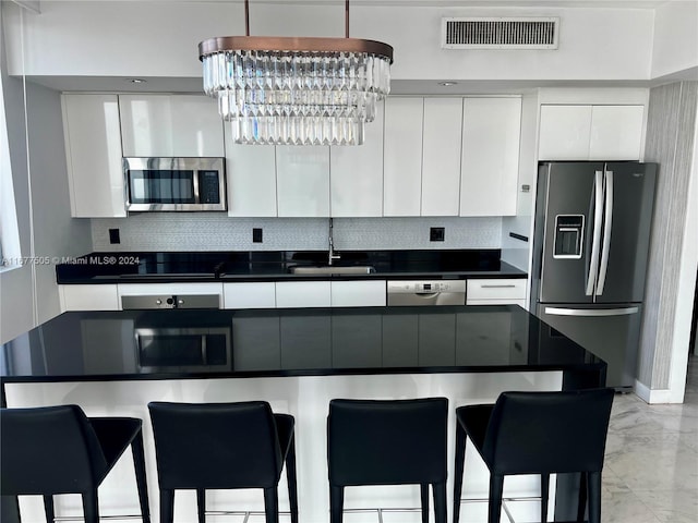 92 SW 3rd Unit 3605, Miami, FL 33130 - kitchen featuring black appliances, dark countertops, a sink, white cabinets, and modern cabinets