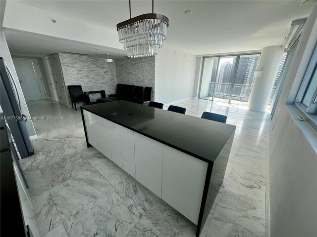 92 SW 3rd Unit 3605, Miami, FL 33130 - kitchen with open floor plan, white cabinets, a large fireplace, modern cabinets, and light marble finish floors