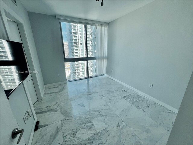 92 SW 3rd Unit 3605, Miami, FL 33130 - spare room with plenty of natural light, marble finish floors, and baseboards
