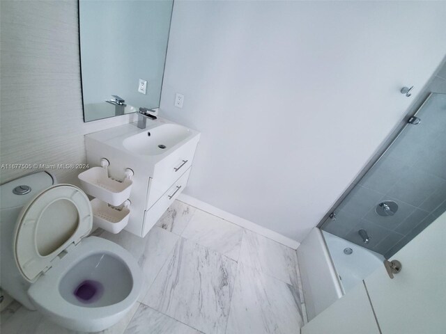 92 SW 3rd Unit 3605, Miami, FL 33130 - bathroom with toilet, marble finish floors, vanity, a bath, and baseboards