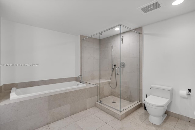 bathroom with toilet, independent shower and bath, and tile patterned floors