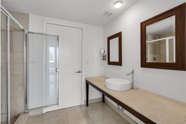 bathroom with vanity, walk in shower, and tile patterned floors