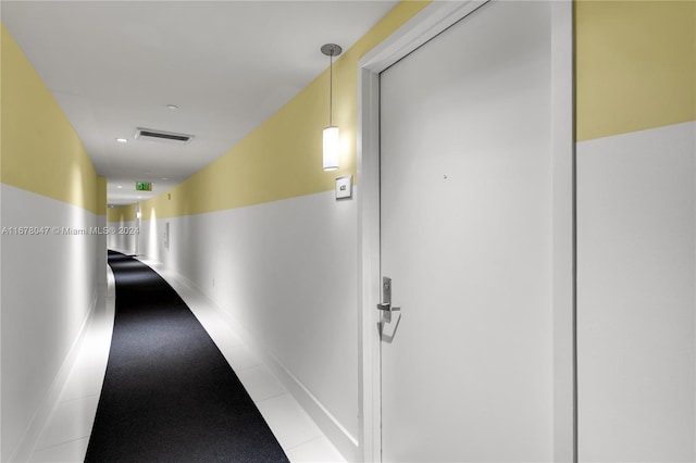 hallway with light tile patterned floors