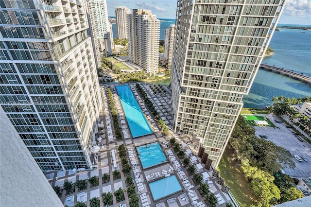 exterior space featuring a community pool and a water view