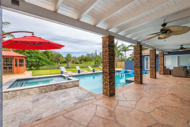 view of pool with an in ground hot tub, ceiling fan, and a patio area