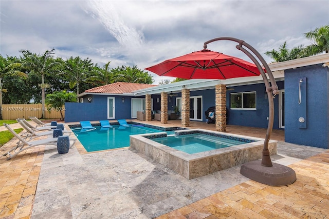 view of pool featuring an in ground hot tub and a patio area