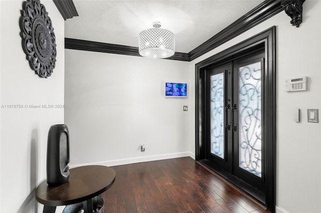 foyer entrance featuring french doors, ornamental molding, a textured ceiling, and dark hardwood / wood-style floors