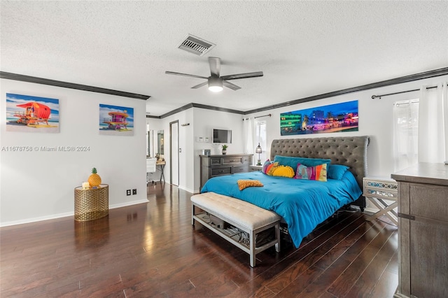 bedroom with ornamental molding, a textured ceiling, dark wood-type flooring, and ceiling fan