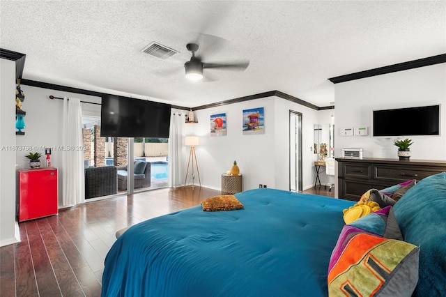 bedroom featuring a textured ceiling, ceiling fan, access to exterior, and dark hardwood / wood-style flooring