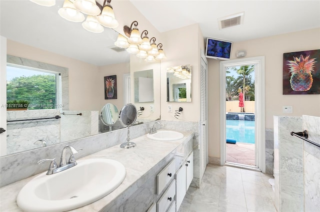 bathroom with vanity and a healthy amount of sunlight