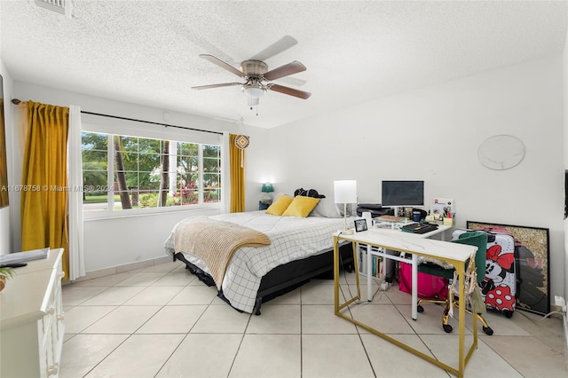 bedroom featuring a textured ceiling, light tile patterned flooring, and ceiling fan