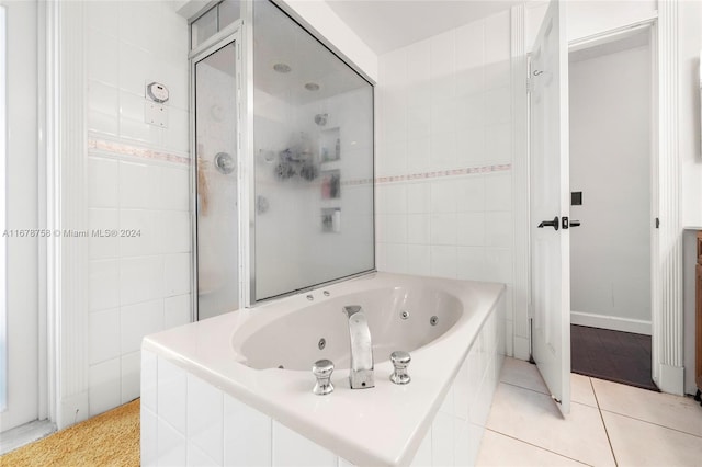 bathroom featuring tile patterned floors and independent shower and bath