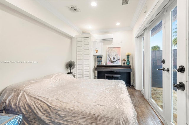 bedroom featuring access to outside, ornamental molding, a closet, and hardwood / wood-style floors