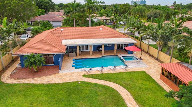 view of swimming pool featuring a yard, a patio area, and an in ground hot tub