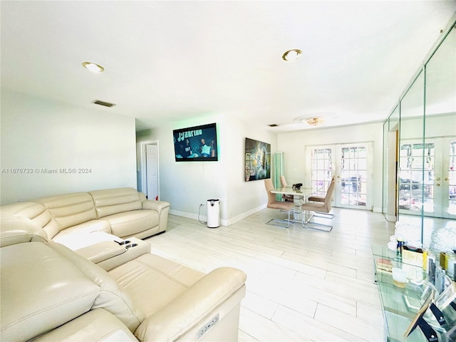 living room with french doors and light hardwood / wood-style floors