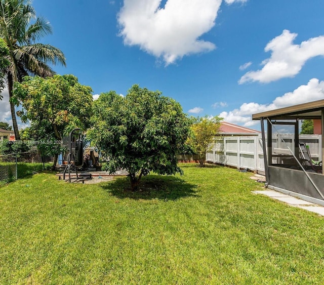 view of yard with a sunroom