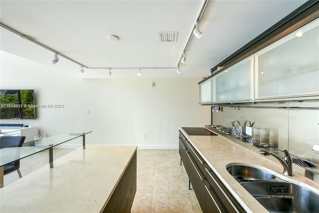 kitchen featuring sink and rail lighting