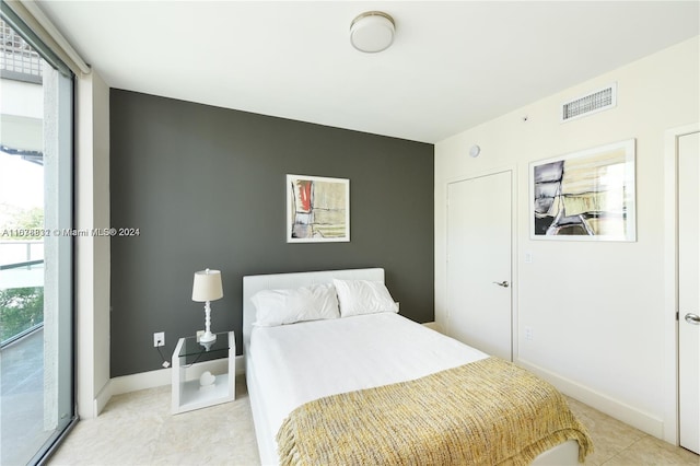 bedroom featuring light tile patterned flooring and access to exterior