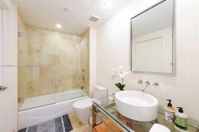 full bathroom with vanity, shower / bath combination with glass door, toilet, and tile patterned floors