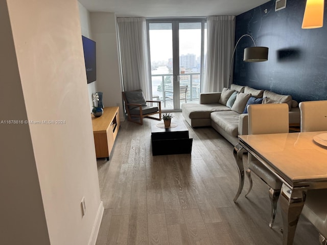 living room featuring french doors, hardwood / wood-style flooring, and floor to ceiling windows