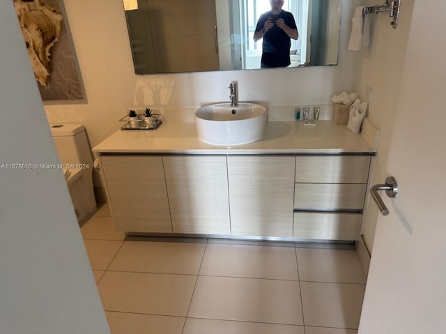 bathroom featuring vanity, toilet, and tile patterned floors