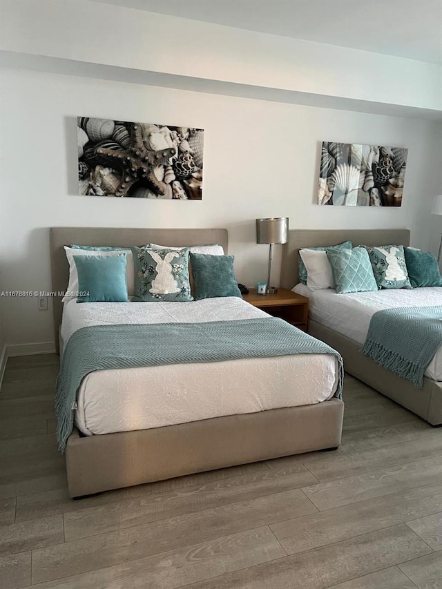 bedroom with wood-type flooring