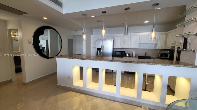 kitchen featuring white cabinetry, dark stone countertops, pendant lighting, and stainless steel fridge with ice dispenser