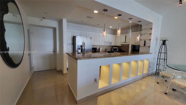 kitchen featuring hanging light fixtures, dark stone counters, white cabinets, light tile patterned floors, and stainless steel refrigerator with ice dispenser