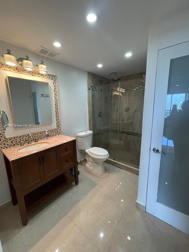 bathroom with vanity, toilet, and an enclosed shower