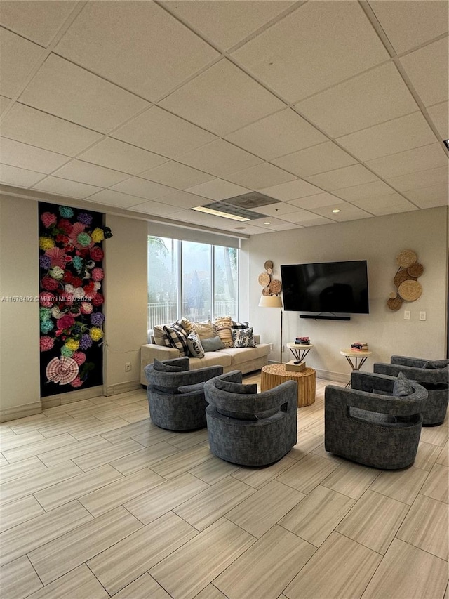 living room featuring a drop ceiling