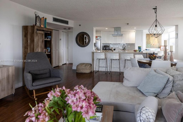 1300 Saint Charles Pl Unit Ph12, Pembroke Pines, FL 33026 - living room with sink, dark hardwood / wood-style flooring, and a textured ceiling
