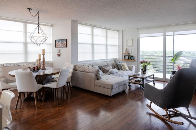 living room with a textured ceiling and dark wood-type flooring