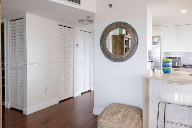 corridor featuring dark hardwood / wood-style flooring