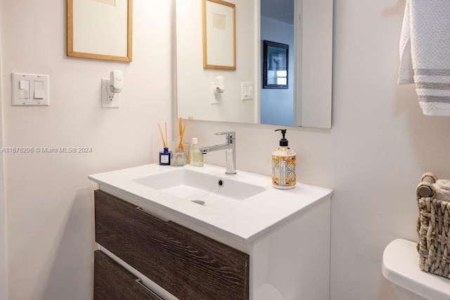 bathroom featuring vanity and toilet