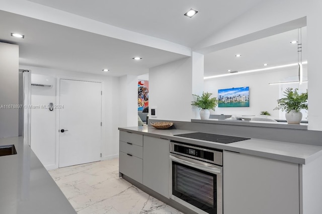 kitchen with black electric stovetop, vaulted ceiling, gray cabinetry, and oven