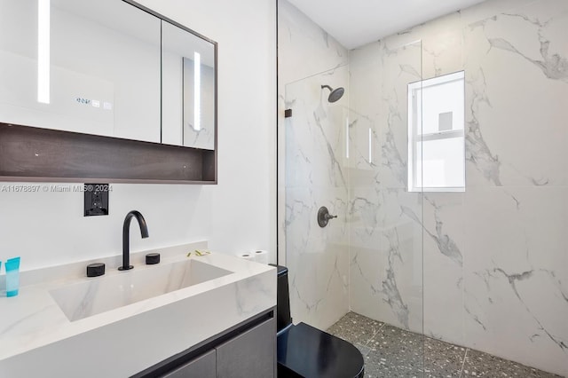 bathroom featuring vanity and tiled shower