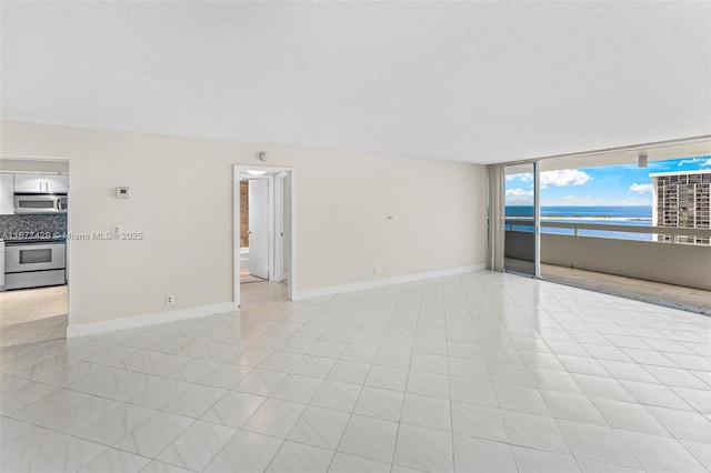 1627 Brickell Ave Unit 1906, Miami, FL 33129 - empty room featuring a water view and baseboards