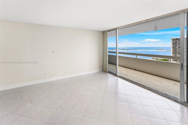 1627 Brickell Ave Unit 1906, Miami, FL 33129 - spare room featuring a water view and baseboards