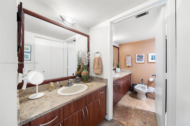 bathroom featuring vanity and a bidet