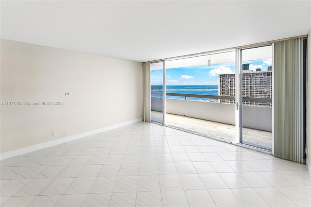 1627 Brickell Ave Unit 1906, Miami, FL 33129 - unfurnished room with a water view and a wall of windows