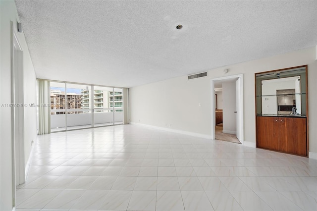 1627 Brickell Ave Unit 1906, Miami, FL 33129 - empty room with expansive windows and a textured ceiling
