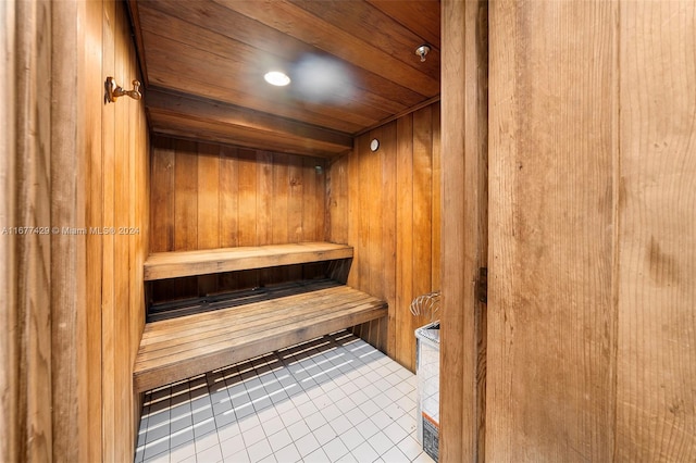 view of sauna / steam room featuring wooden walls, wooden ceiling, and tile patterned floors