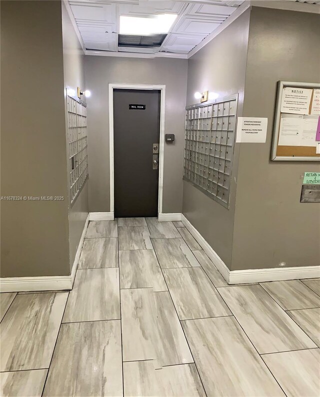 foyer entrance with elevator and mail boxes