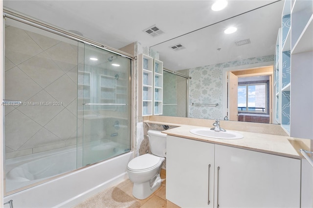 full bathroom with toilet, enclosed tub / shower combo, vanity, and tile patterned flooring